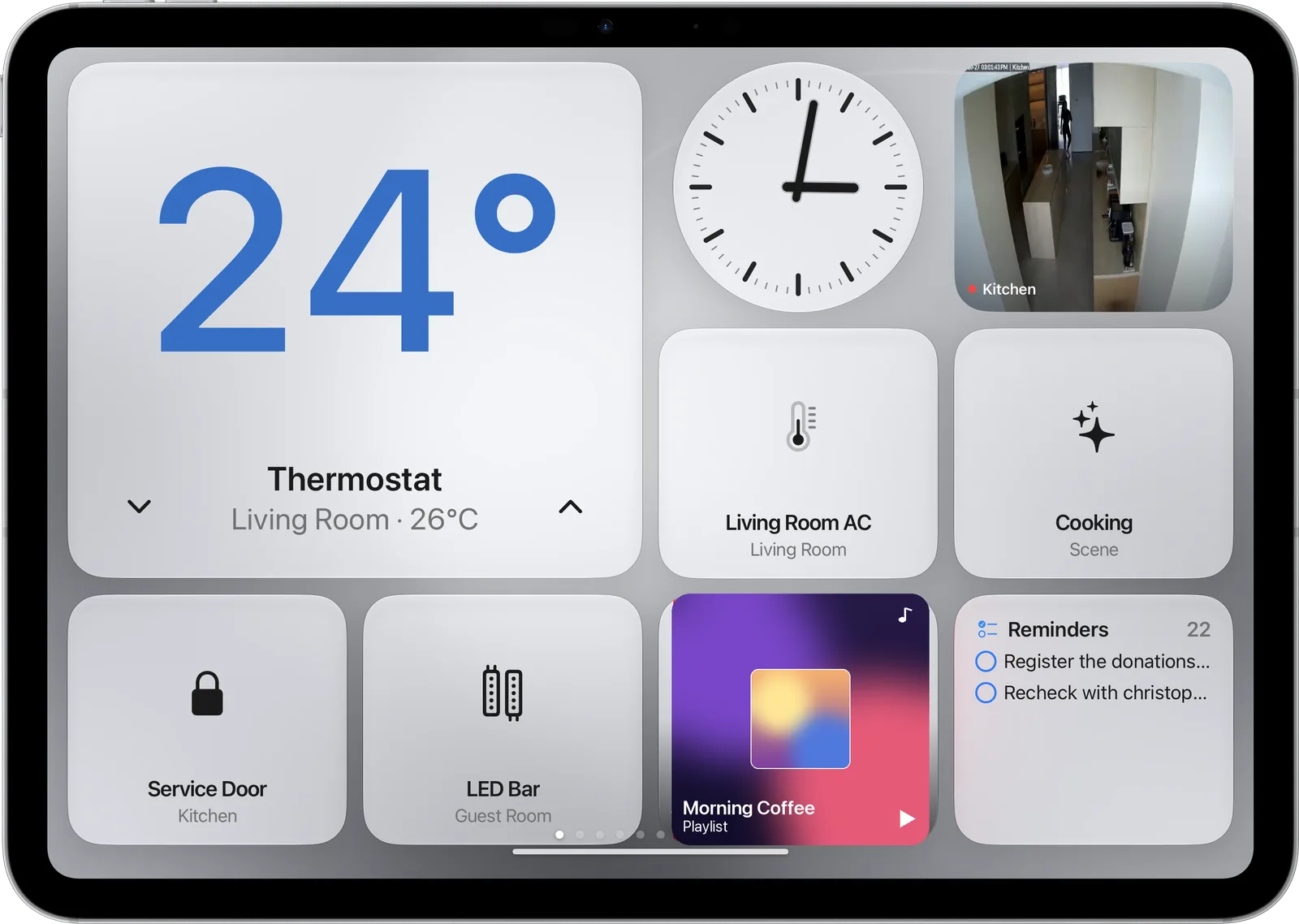 Silver iPad showing the dashboard in grey with a thermostat, lights, a lock and reminders