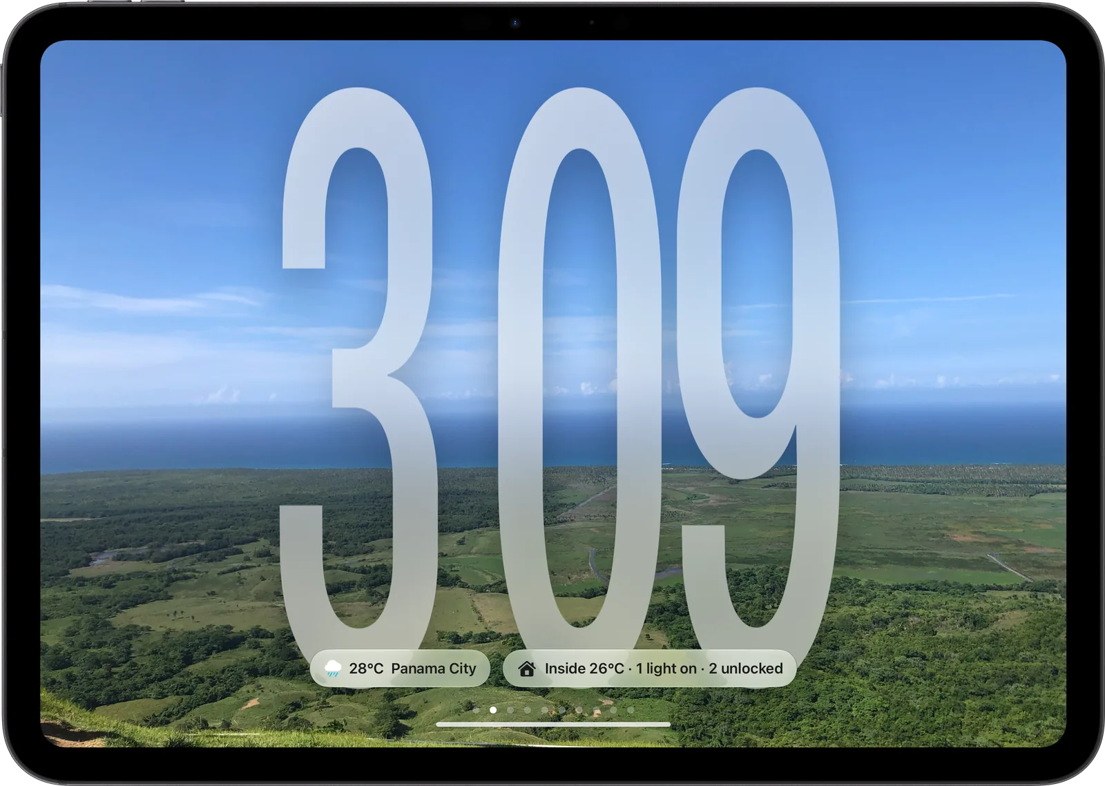 Glass face: large frosted numerals over a landscape photo